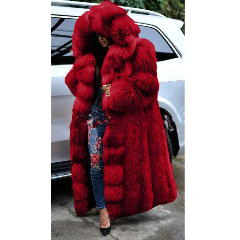 Bright red, oversized faux fur coat with a large hood, worn for winter warmth.