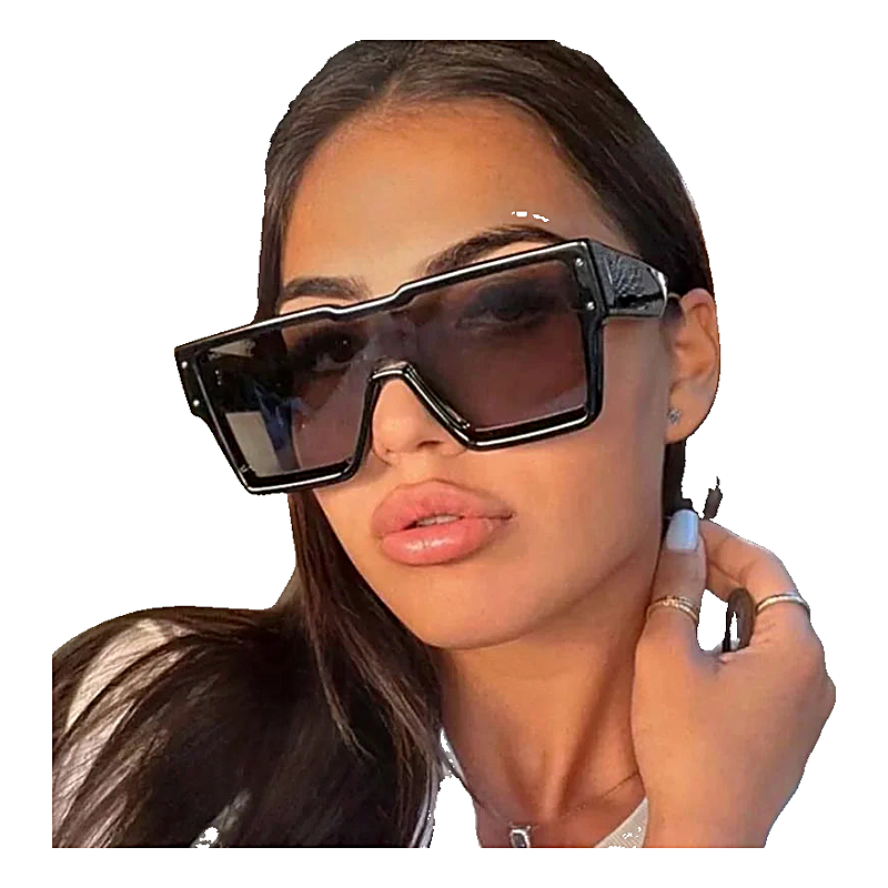 Woman wearing oversized square sunglasses with thick black frames and gradient lenses.