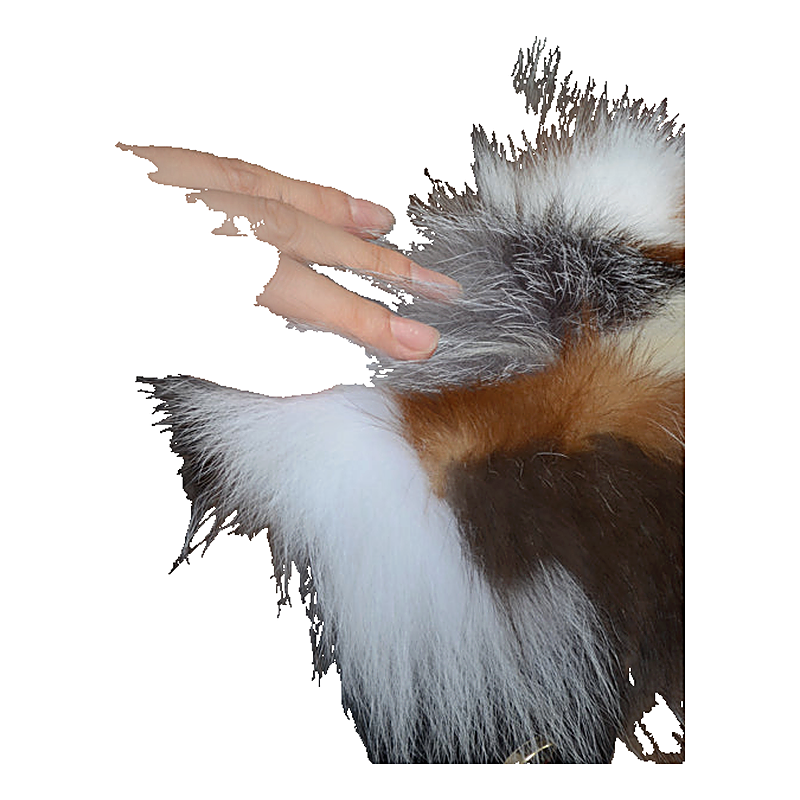 A hand rests on a multicolored faux fur handbag showing white, brown, and dark gray patches.