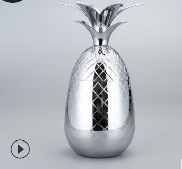 Polished silver pineapple-shaped tumbler with textured diamond pattern and matching leaf lid.