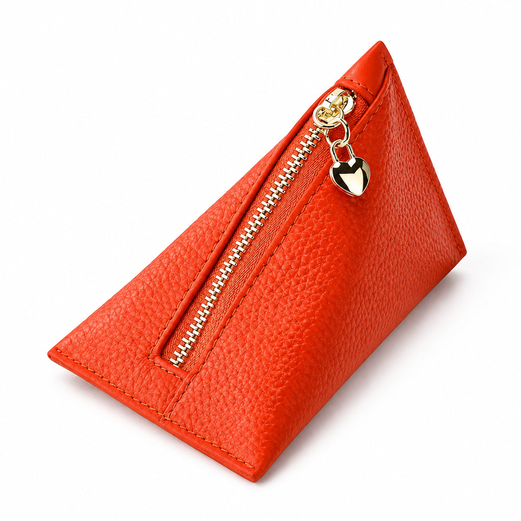 Orange textured leather triangular coin purse with a gold zipper and dangling heart charm.