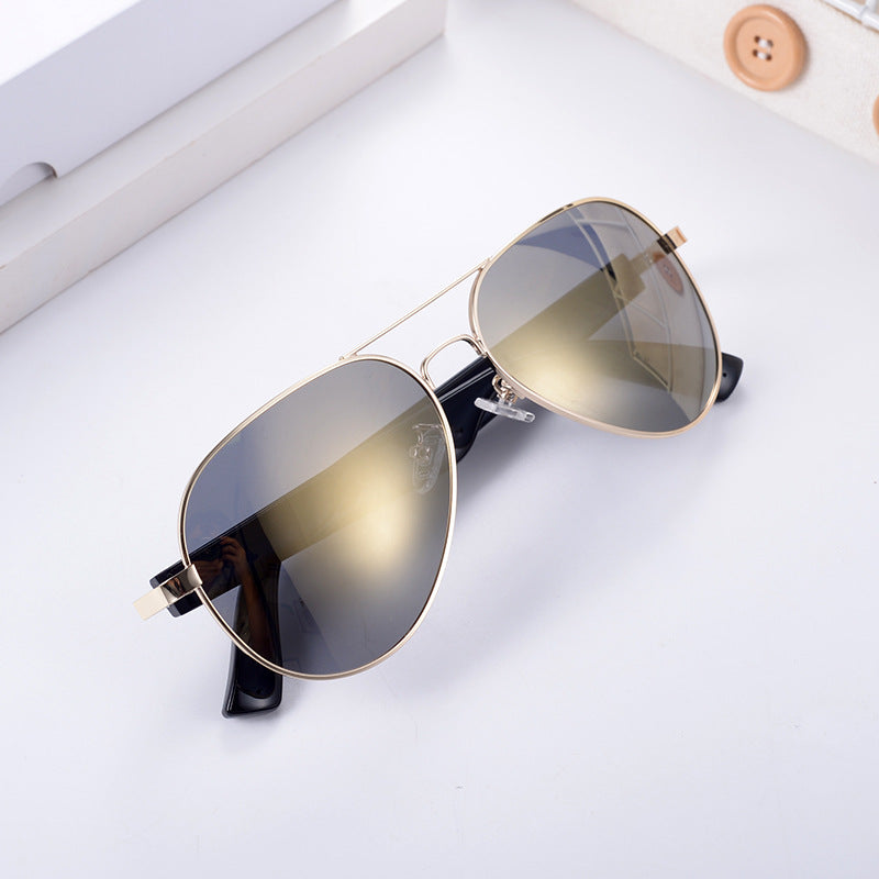 Gold-rimmed aviator smart wearables with polarized lenses for real-time translation during travel.