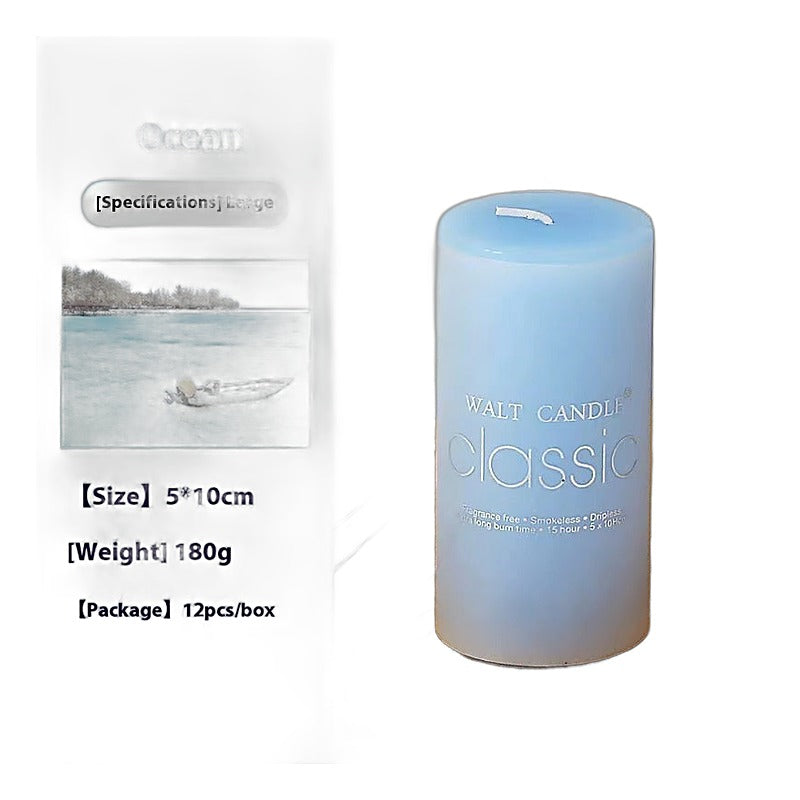 Home decor scented blue cylindrical wax pillar candle on a wooden tray with an ocean
