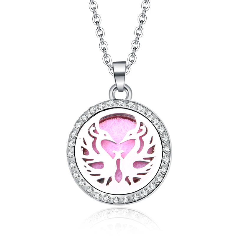 Silver-tone metal aromatherapy diffuser necklace with crystal-rimmed phoenix locket and pink pad for essential oils.