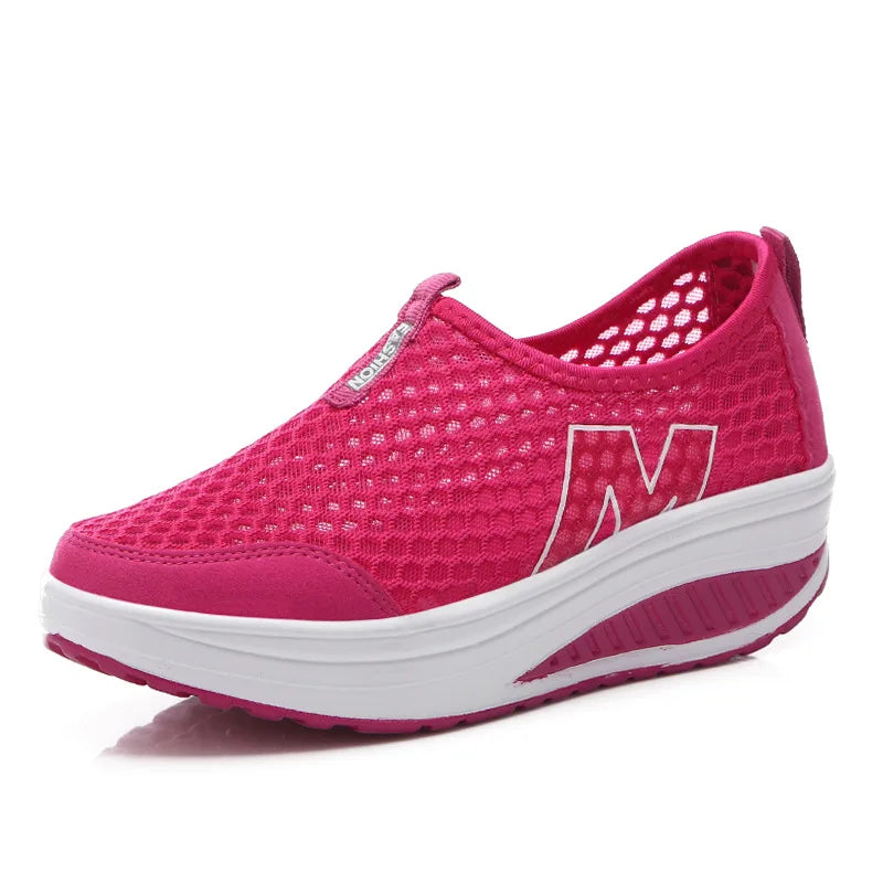 Hot pink breathable mesh slip-on platform sneakers with a white sole for comfortable all-day wear.
