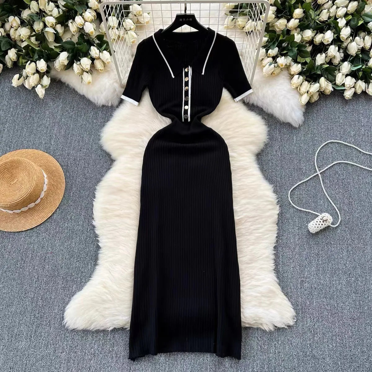 Black ribbed knit midi dress with white trim, polo neck, and buttons. A fitted piece for a polished daytime outfit.