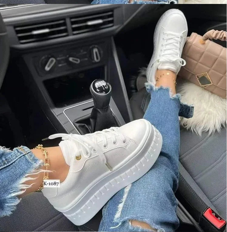 White lace-up platform sneakers with cushioned soles for comfortable everyday wear.