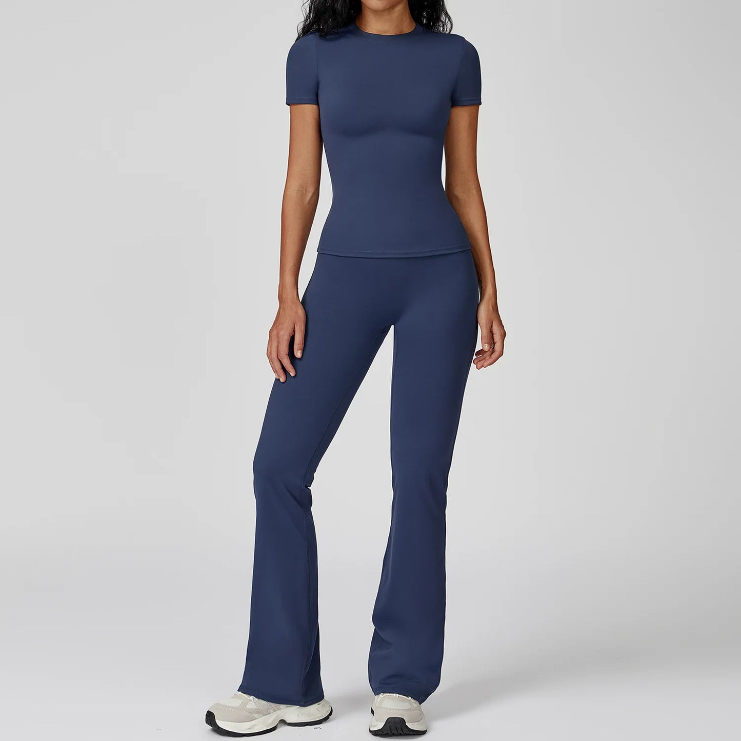 Navy blue seamless, stretchy yoga set with a fitted top and high waist flared leggings for gym workouts.