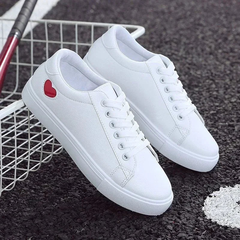 White leather platform sneakers with red heart detail and cushioned insole for everyday street style.