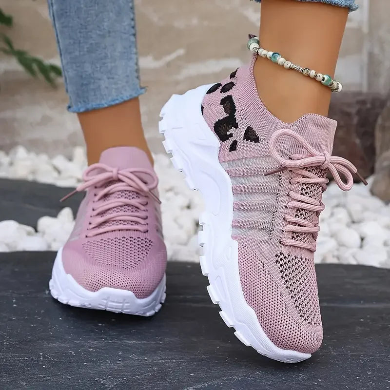Pink knit sneakers with a leopard print pattern, white cushioned platform soles, and laces for daily comfort.