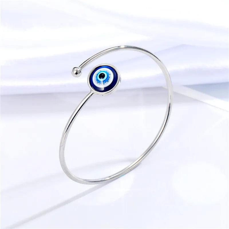 Adjustable cuff bracelet with a geometric evil eye motif