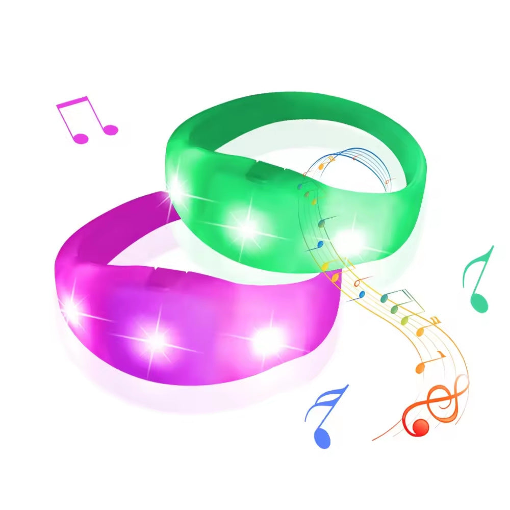Green and pink glowing LED wristbands with light effects and musical notes.