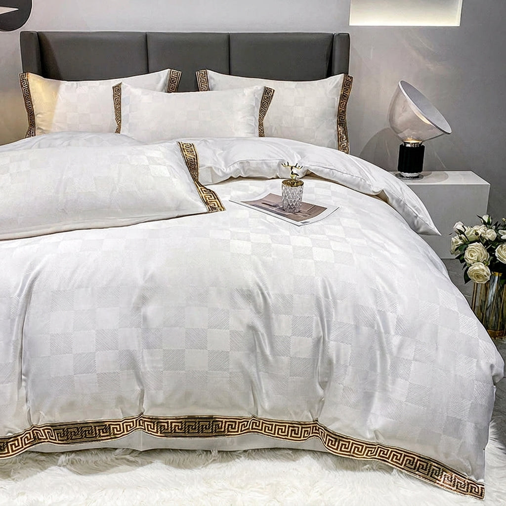White checkered bed sheet set with a quilt cover and a gold geometric key border on pillows and duvet.