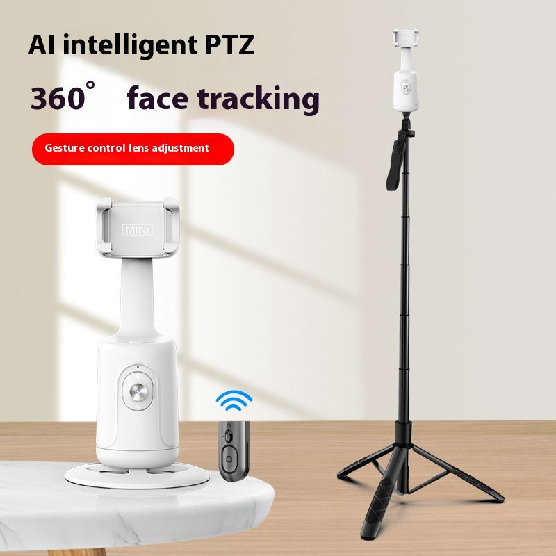 White face-tracking phone gimbal on a white base next to a remote, with an extended tripod standing upright.