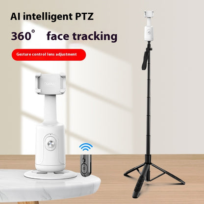 White face-tracking phone gimbal on a white base next to a remote, with an extended tripod standing upright.