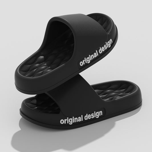 Two black cushioned slide sandals stacked on a light gray background.