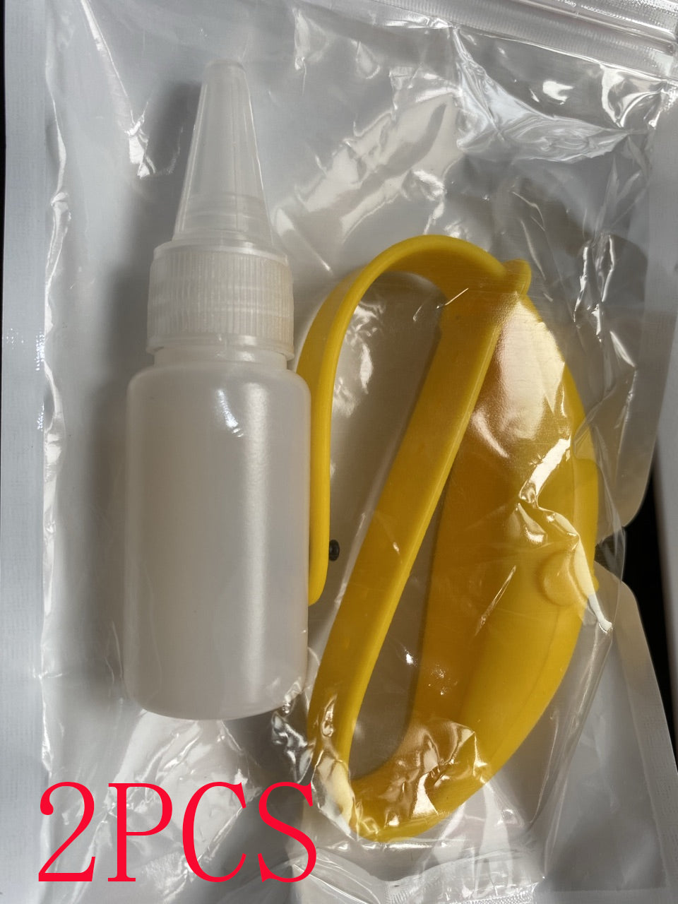 Yellow silicone wristband and refill bottle in a clear plastic bag.