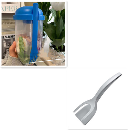 Clear salad cup with blue lid and blue spork holding a green vegetable salad