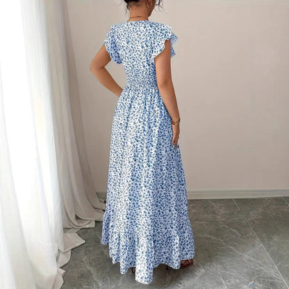Blue and white floral polyester flowy dress with ruffled sleeves and a smocked waist for resortwear.