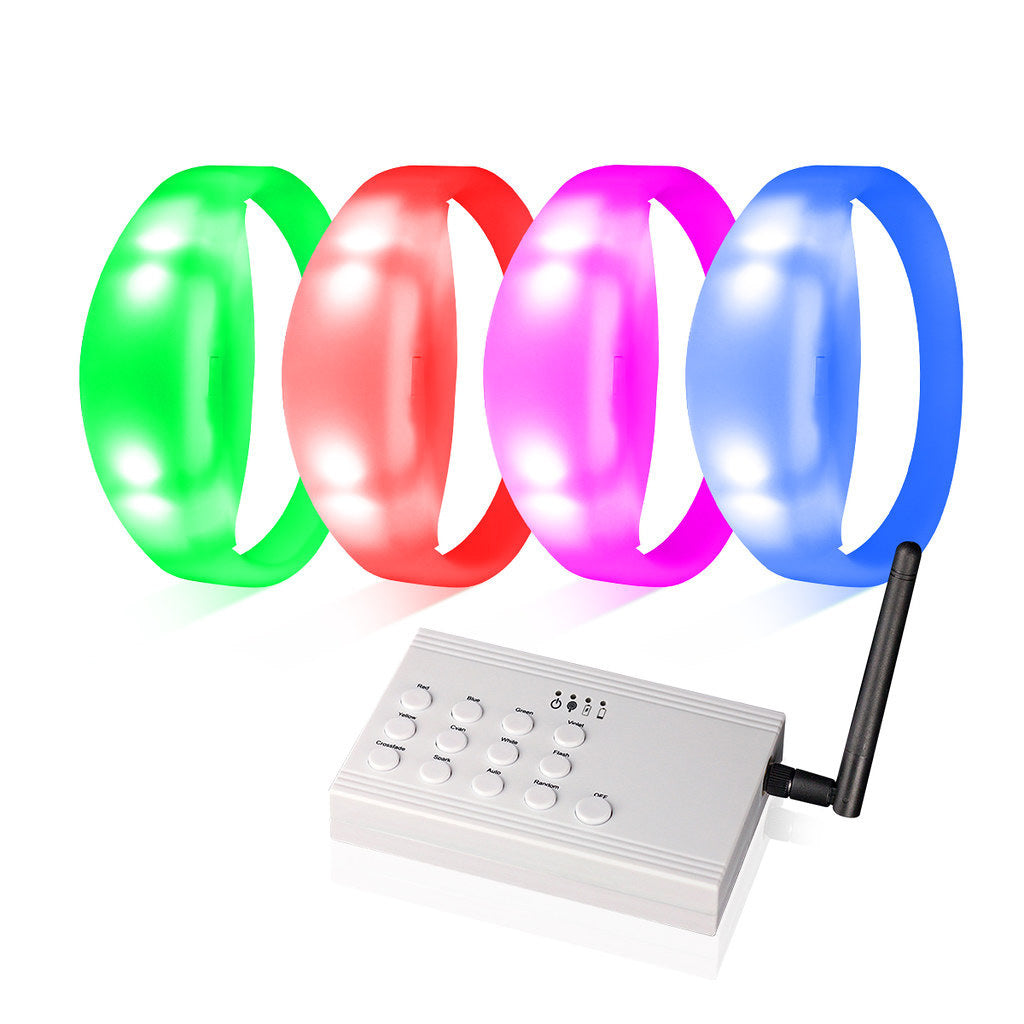 Four glowing LED wristbands in green, red, pink, and blue above a white remote control with an antenna.