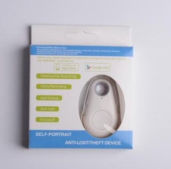 White, teardrop-shaped waterproof Bluetooth tracker in retail packaging for tracking keys and personal belongings.