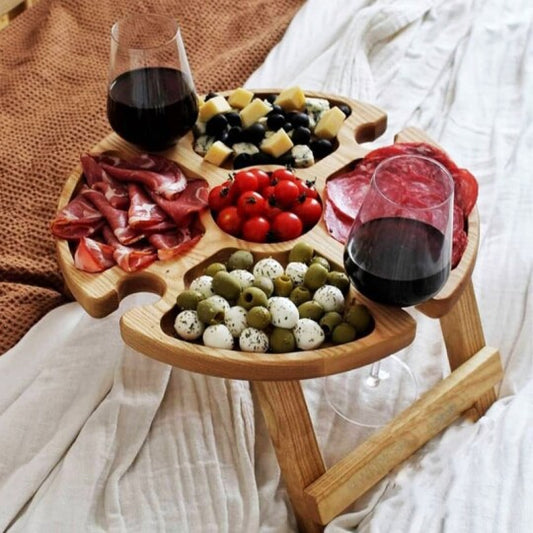 Folding wooden picnic table with wine glass holders and food compartments