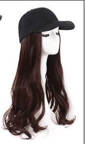 Mannequin head wearing a black baseball cap with long wavy brown hair attached.