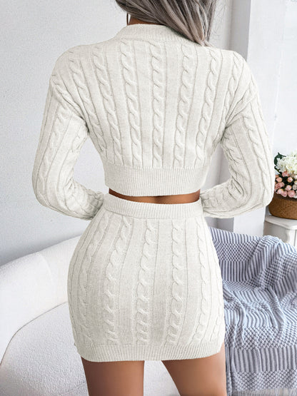 Off-white cable knit two-piece set with a sculpting fitted silhouette, worn as a matching sweater and skirt outfit.