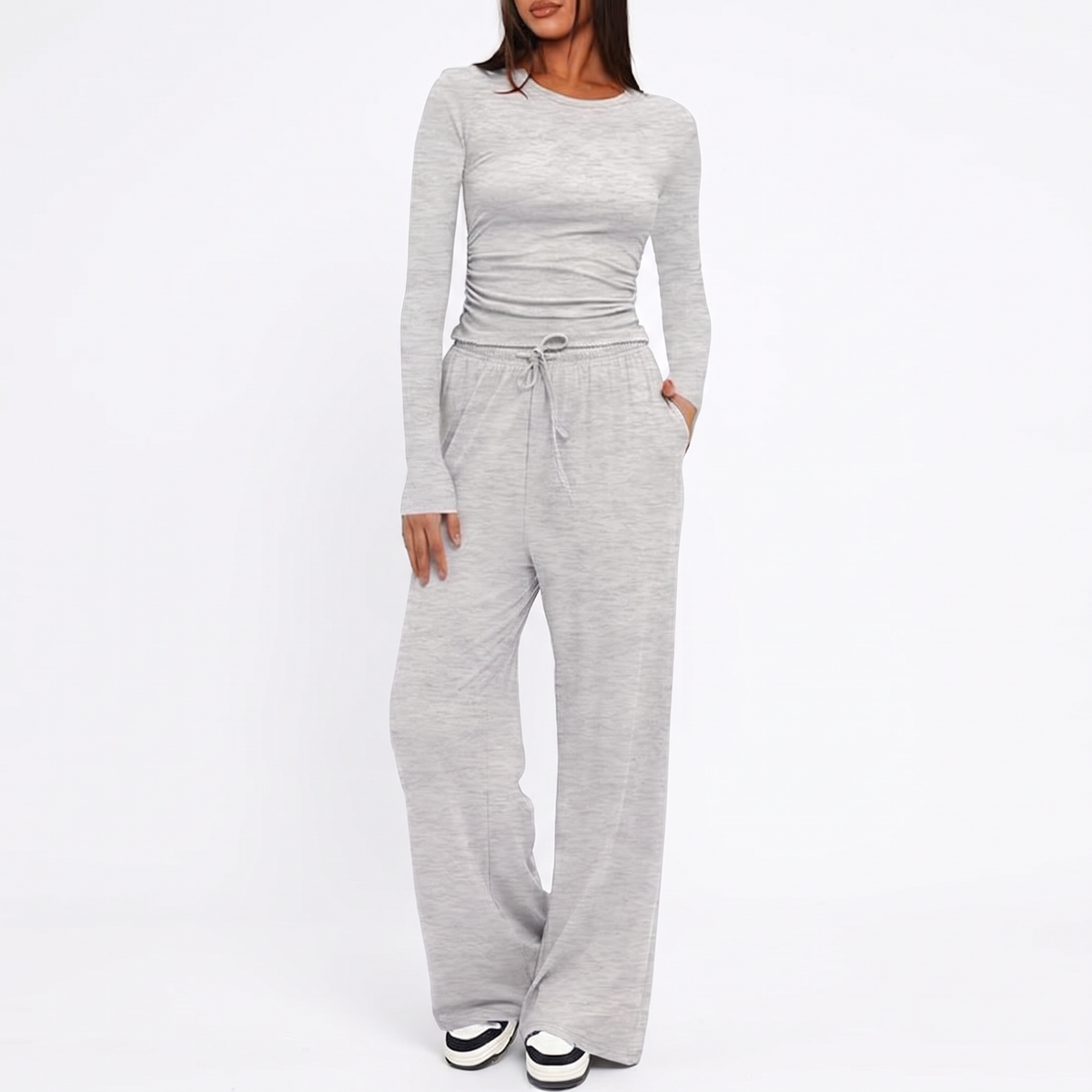 Grey ribbed two-piece loungewear set featuring a long-sleeve top and high-waist wide-leg pants with a drawstring.