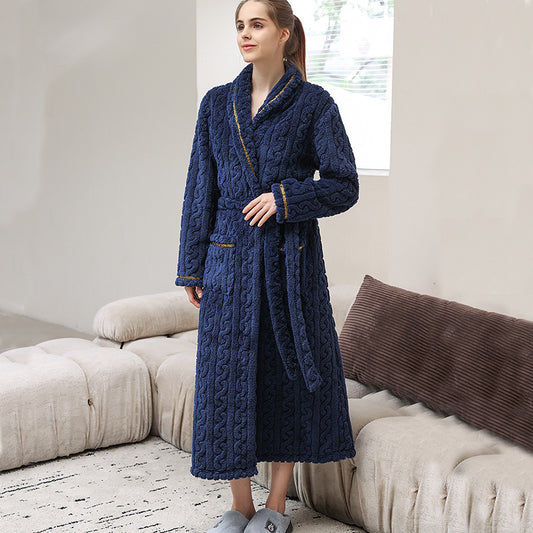 Woman wearing a navy blue cable knit microfleece bathrobe with a shawl collar and tie belt.