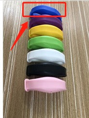 Blue silicone refillable hand sanitizer wristband highlighted from a vertical stack of various colored bands.