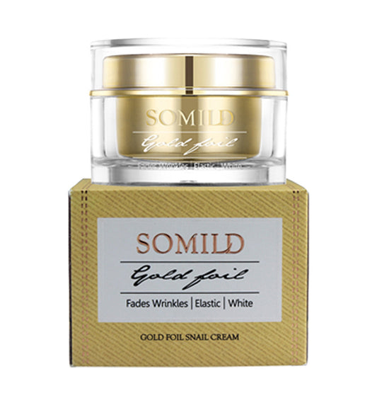 Gold foil face cream jar resting on top of its matching product box.