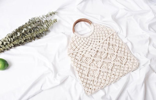 Macrame net handbag with round wooden handles, side view