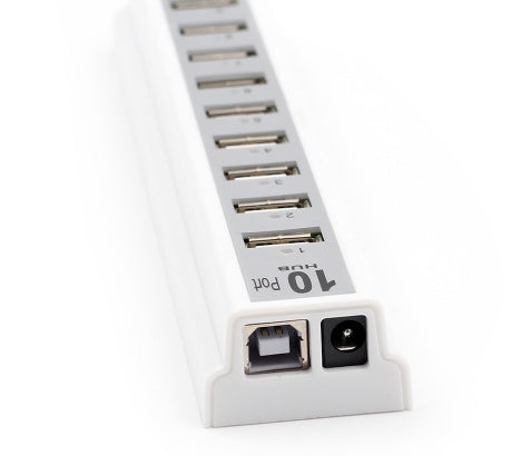 White 10-port USB hub angled view showing power input and host port on end.