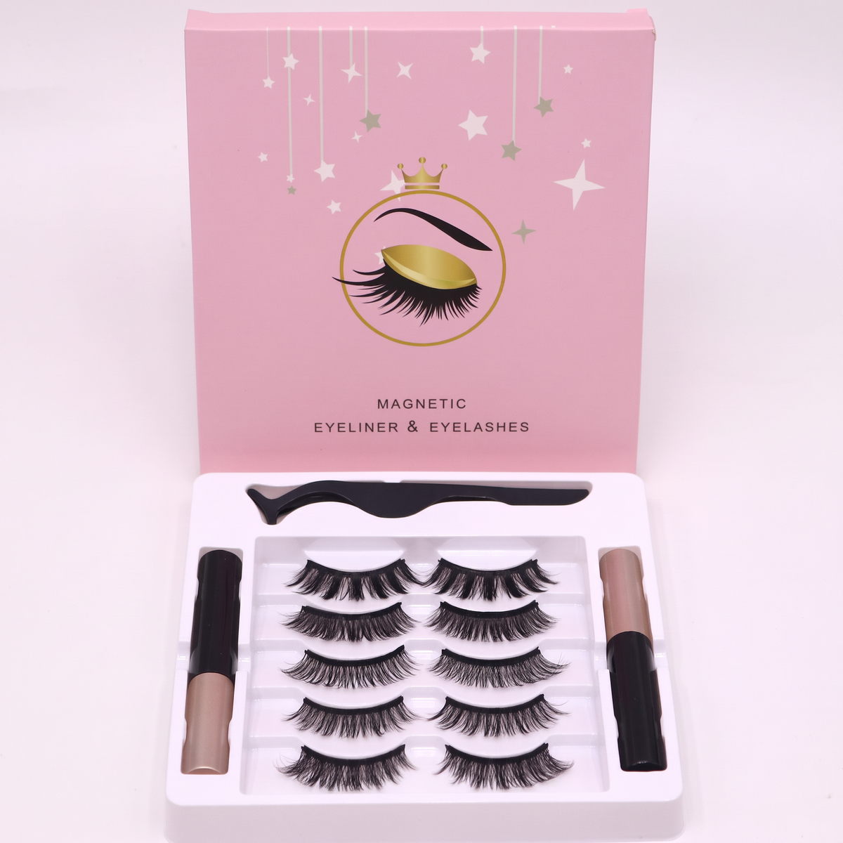 Magnetic eyelash kit in a pink box with five pairs of strip lashes, black eyeliner tubes, and tweezers.