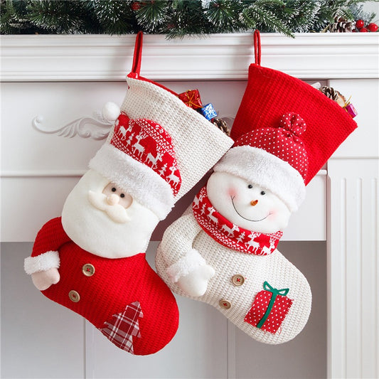 Santa and snowman knitted Christmas stockings hanging on a mantel.