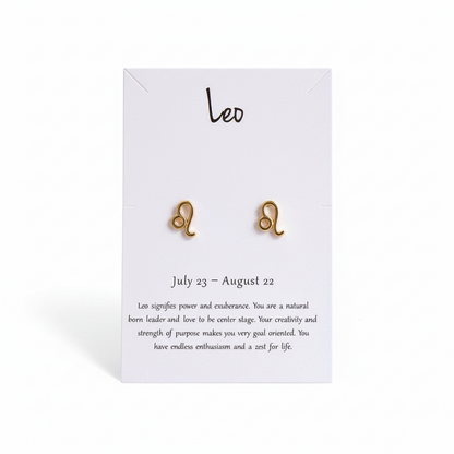 Gold Leo zodiac sign stud earrings on white paper display card.