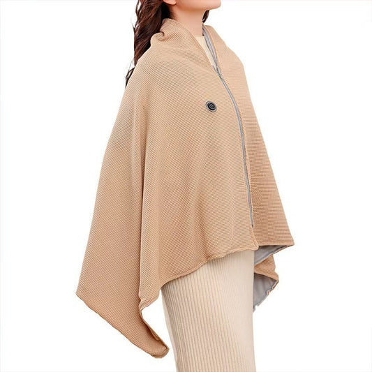 Woman wearing a textured beige heated shawl wrap with a front zipper and control button, side angle view.