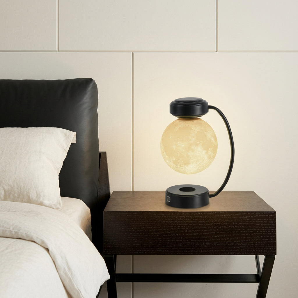Black levitating moon lamp on a dark wood nightstand