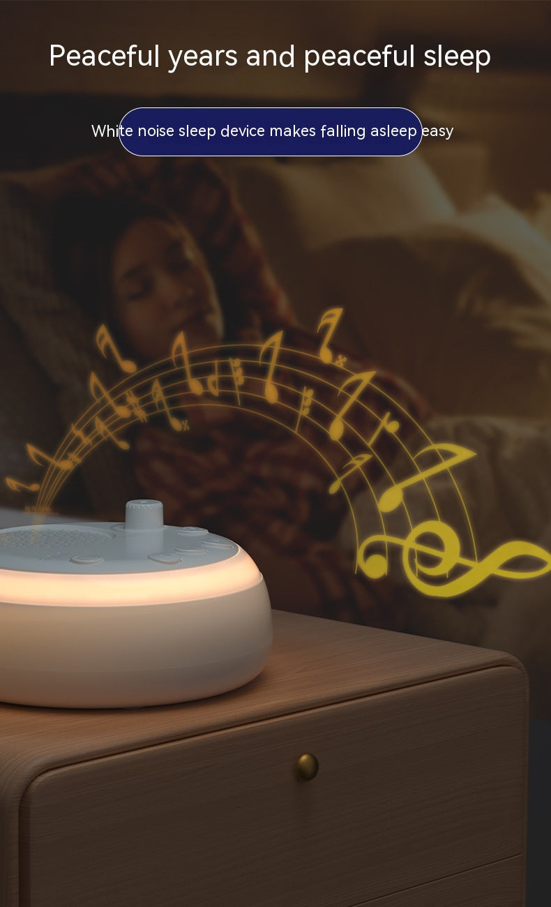 White noise sleep machine with a glowing base on a bedside table with a sleeping person in the background