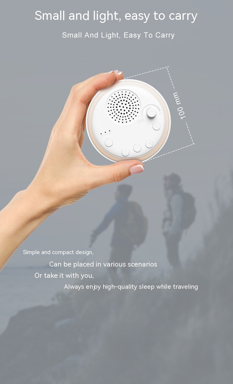 A hand holding a round white portable sleep sound machine with buttons and a speaker grill, showing its 100 mm size.