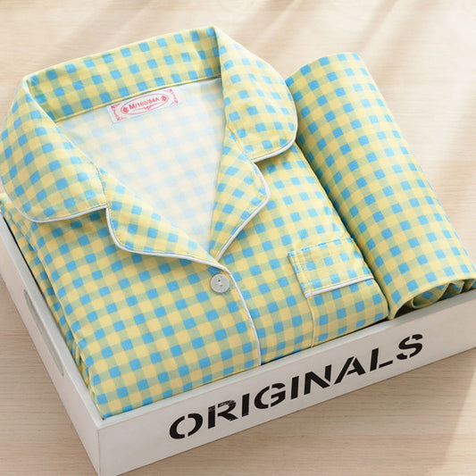 Yellow and blue plaid button-up pajama set with white piping in a wooden box