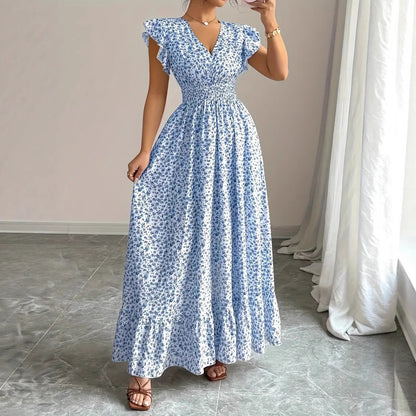 Blue and white floral print flowy dress in polyester for resortwear with a ruffled flutter sleeve and smocked waist.