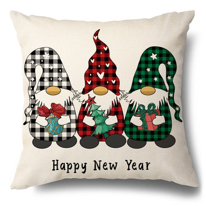 Square pillow cover featuring three gnomes in buffalo plaid hats holding holiday items above Happy New Year text.