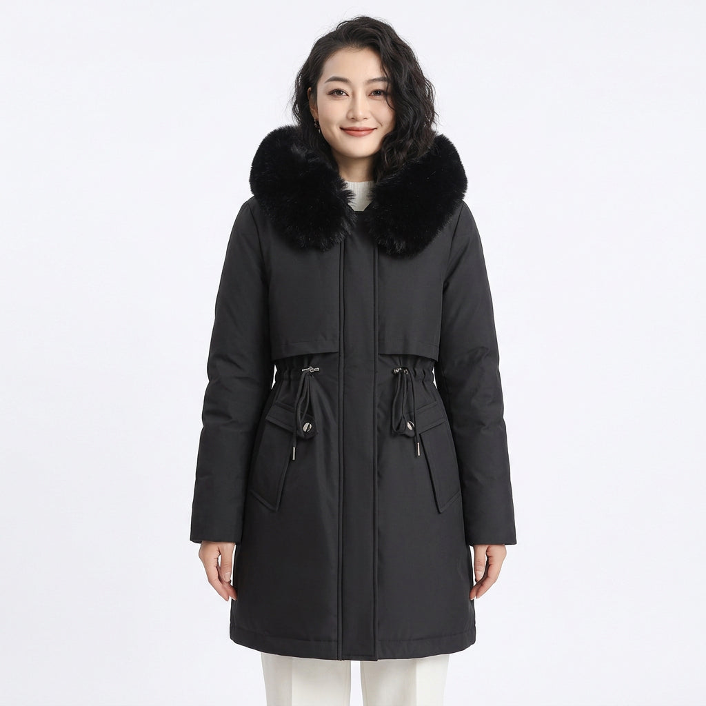 Woman wearing a black puffer coat with a large black faux fur collar and drawstring waist.