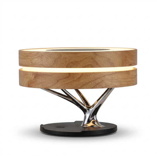 Wooden bedside lamp with a glowing ring shade and a metallic tree branch base on a nightstand.