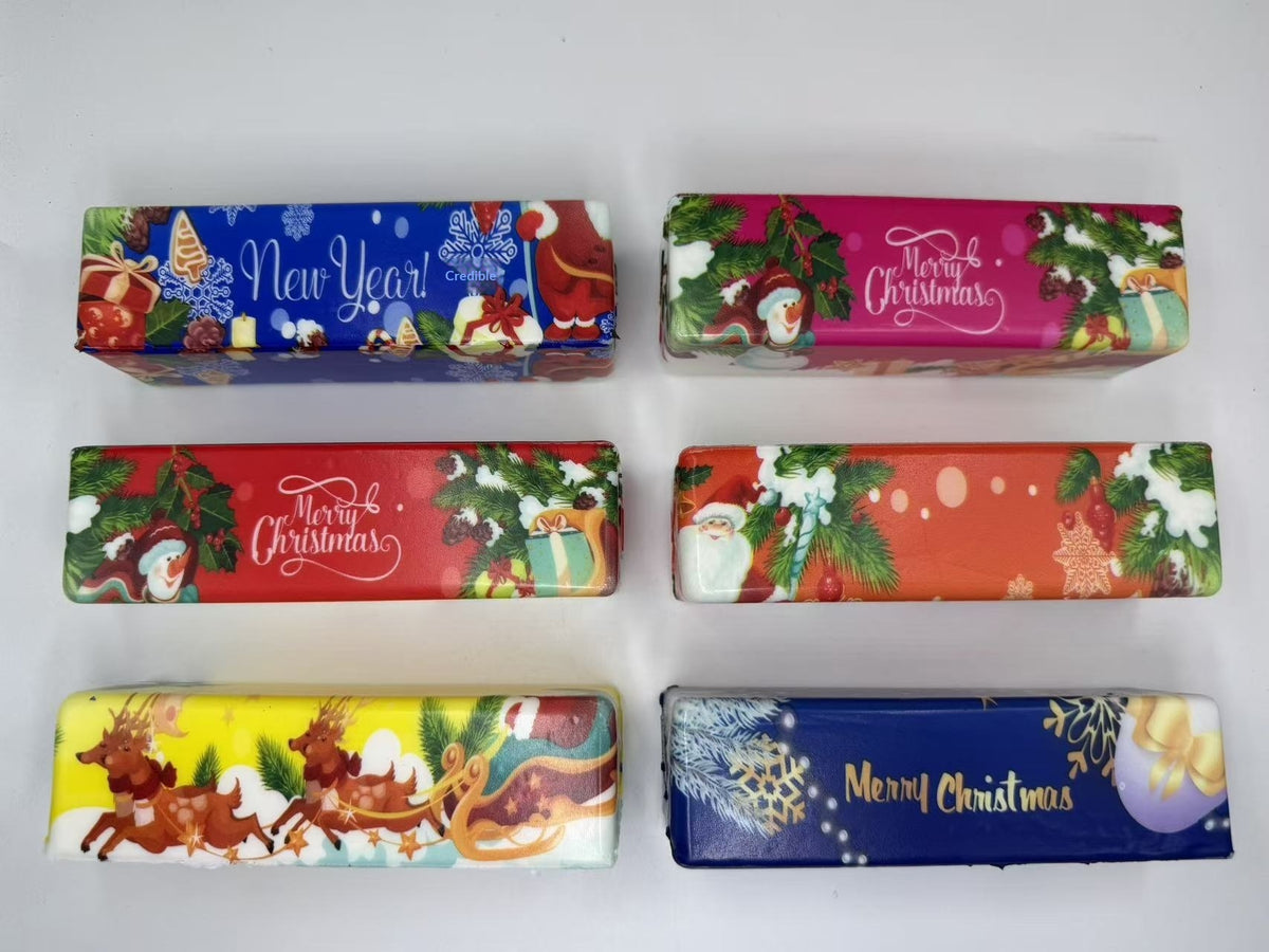 Six rectangular squishy toys with colorful Christmas and New Year designs against a white background.