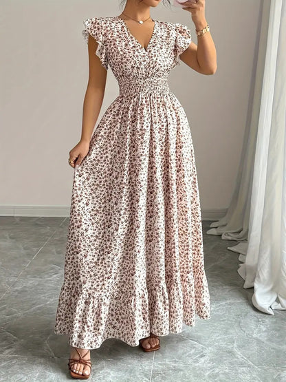 White polyester floral dress with flowy skirt, v-neck, and flutter sleeves, ideal for resortwear.