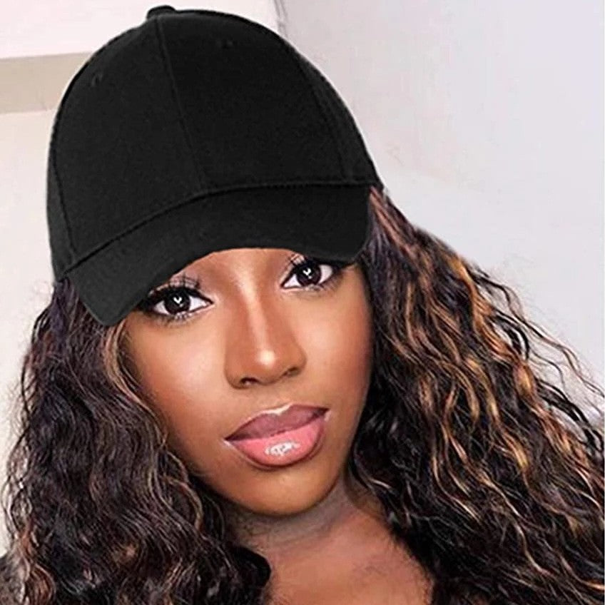 Close-up front view of a person wearing a black baseball cap with long wavy brown-highlighted hair.