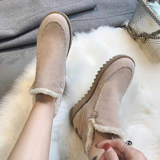 Womens beige suede winter boots with wool lining and stitching on fluffy rug